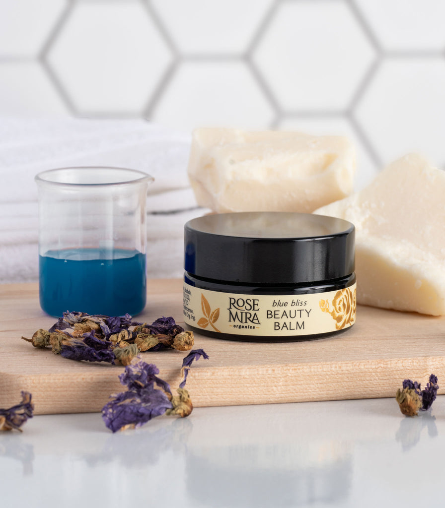 Blue Bliss Beauty Balm with blue tansy, dried purple flowers, shea butter chunks.