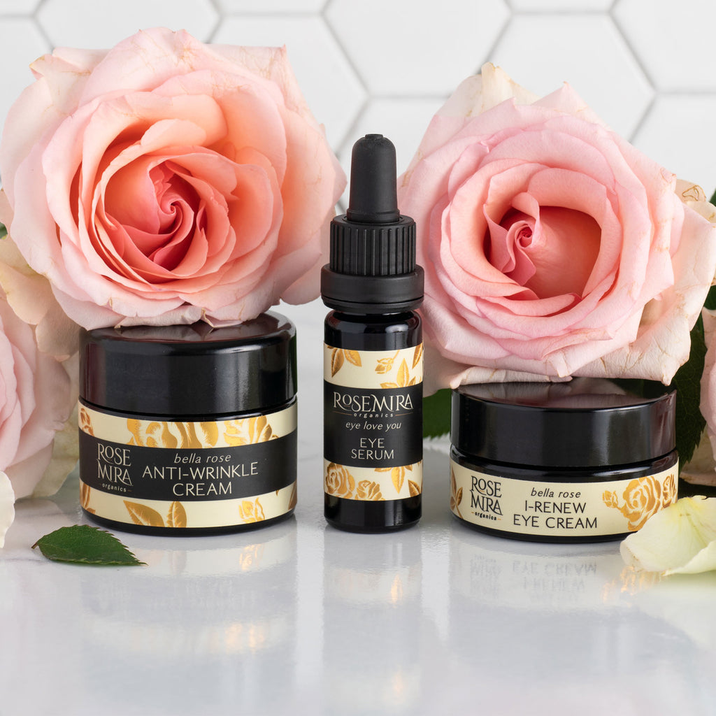 Three Rosemira products lined up with pink roses