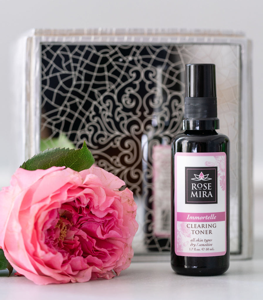 Immortelle Clearing Toner with a mirror box and a single pink rose