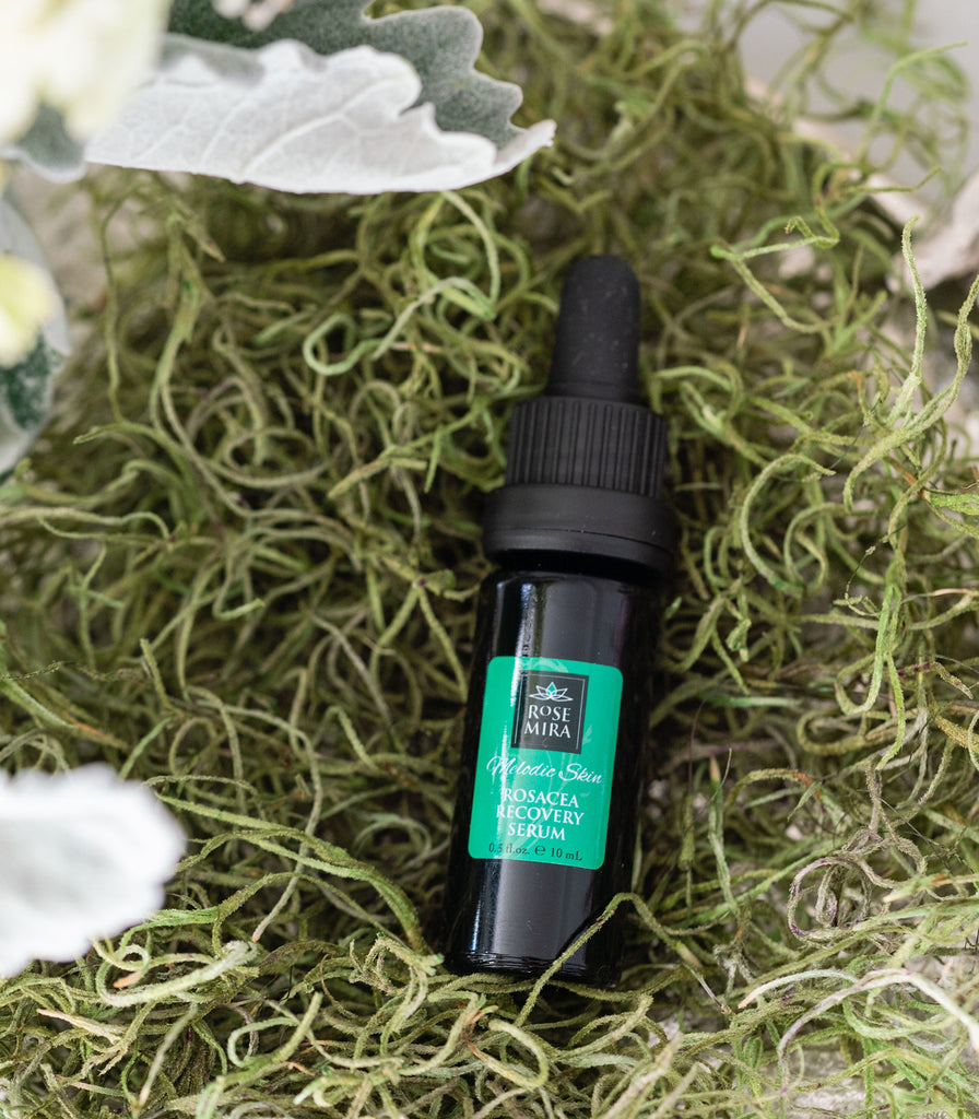 Melodic Skin Rosacea Recovery Serum in a bowl of dry moss.