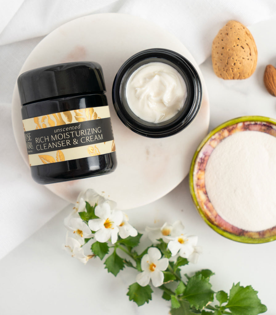 Unscented Moisturizing Cream with white flowers, ingredients, and an open jar showing rich white contents.