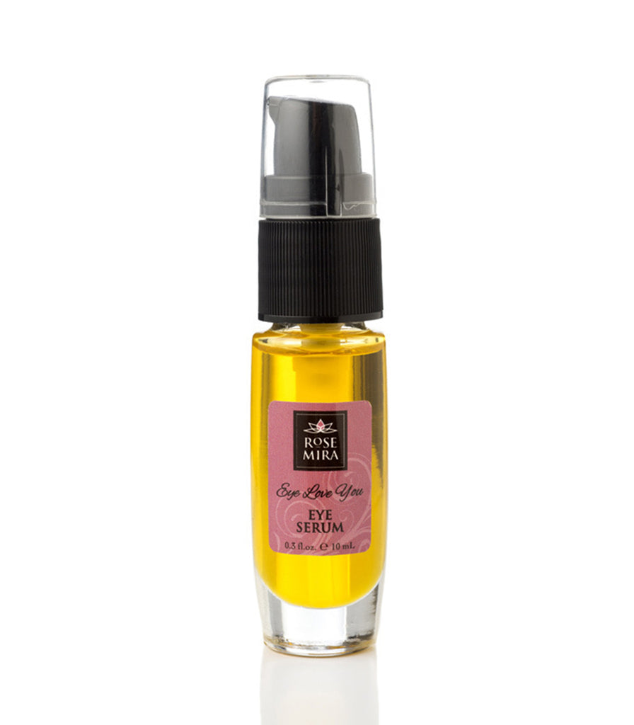 A clear bottle of eye serum showing the golden color.
