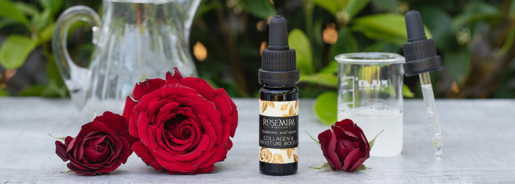 Hyaluronic Acid Serum with red roses and a beaker of clear liquid.