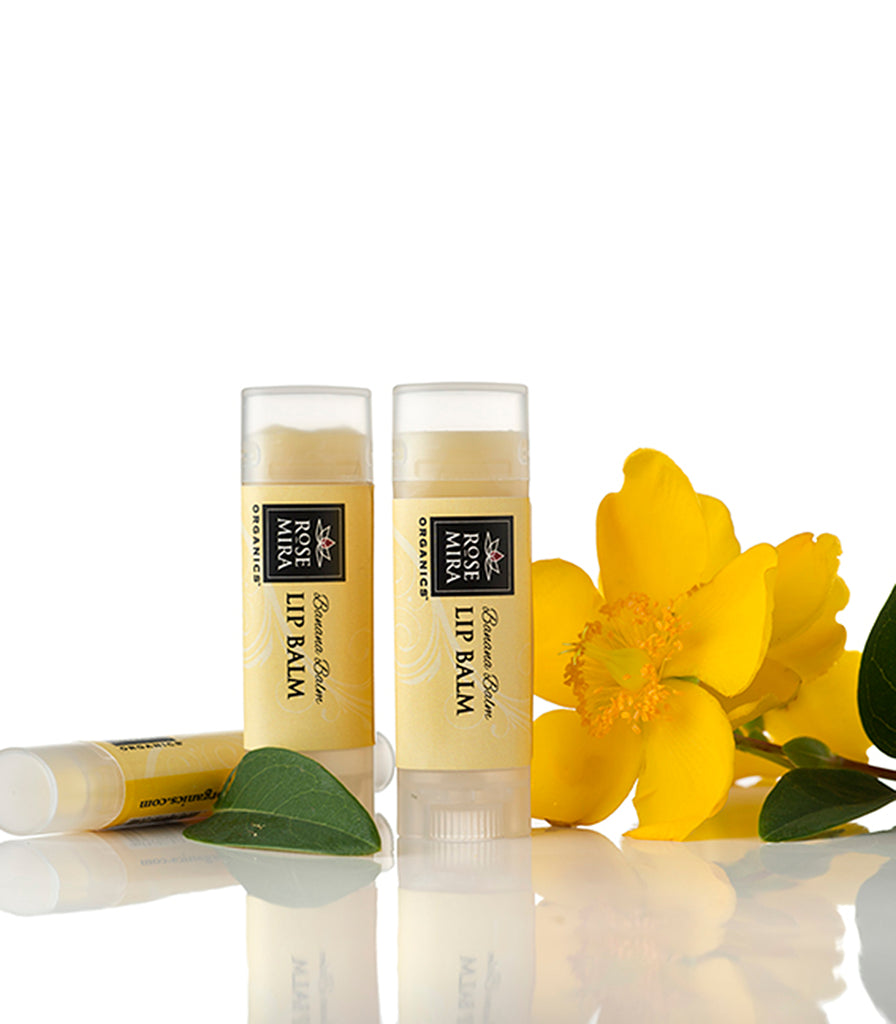 Three containers of Banana organic lip balm with yellow label and flower