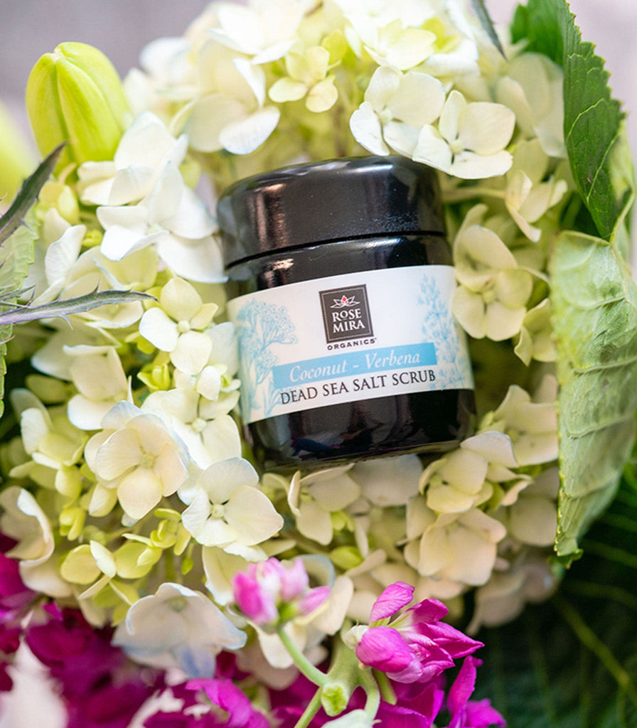 Coconut Verbena Dead Sea Salt Scrub in a bouquet of white hydrangea