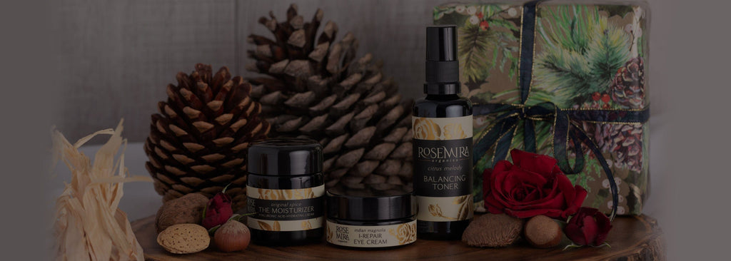Rosemira skincare with gift wrapped present, pinecones, and roses.