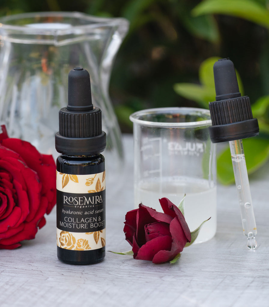 Hyaluronic acid serum with a beaker of aloe and red roses