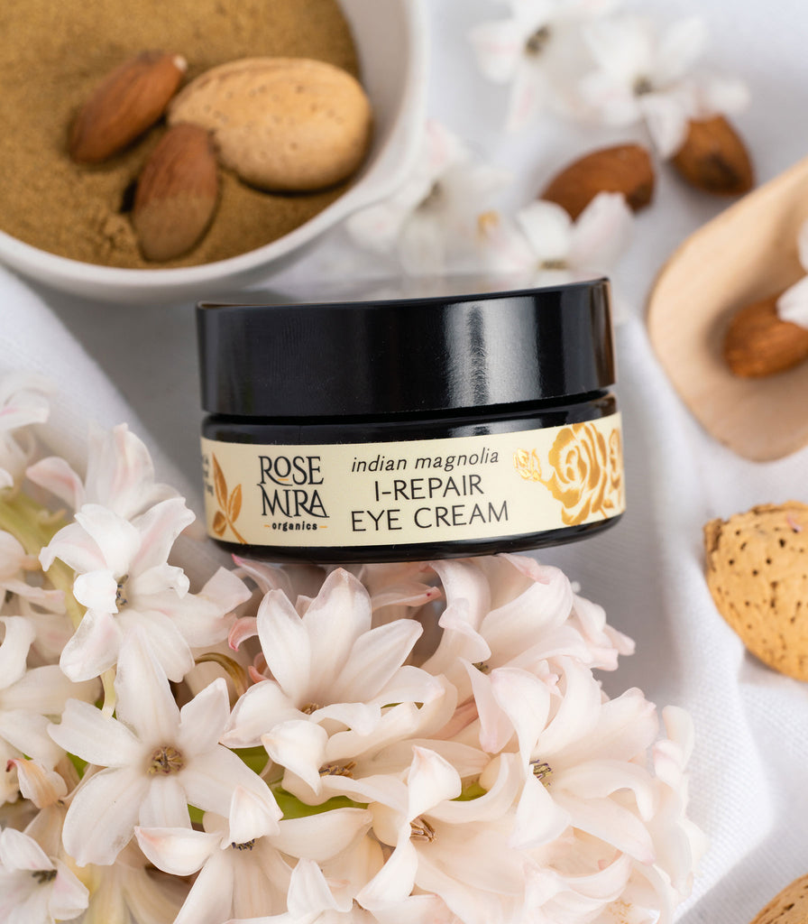 Indian Magnolia I-Repair Eye Cream with white flowers and almonds.
