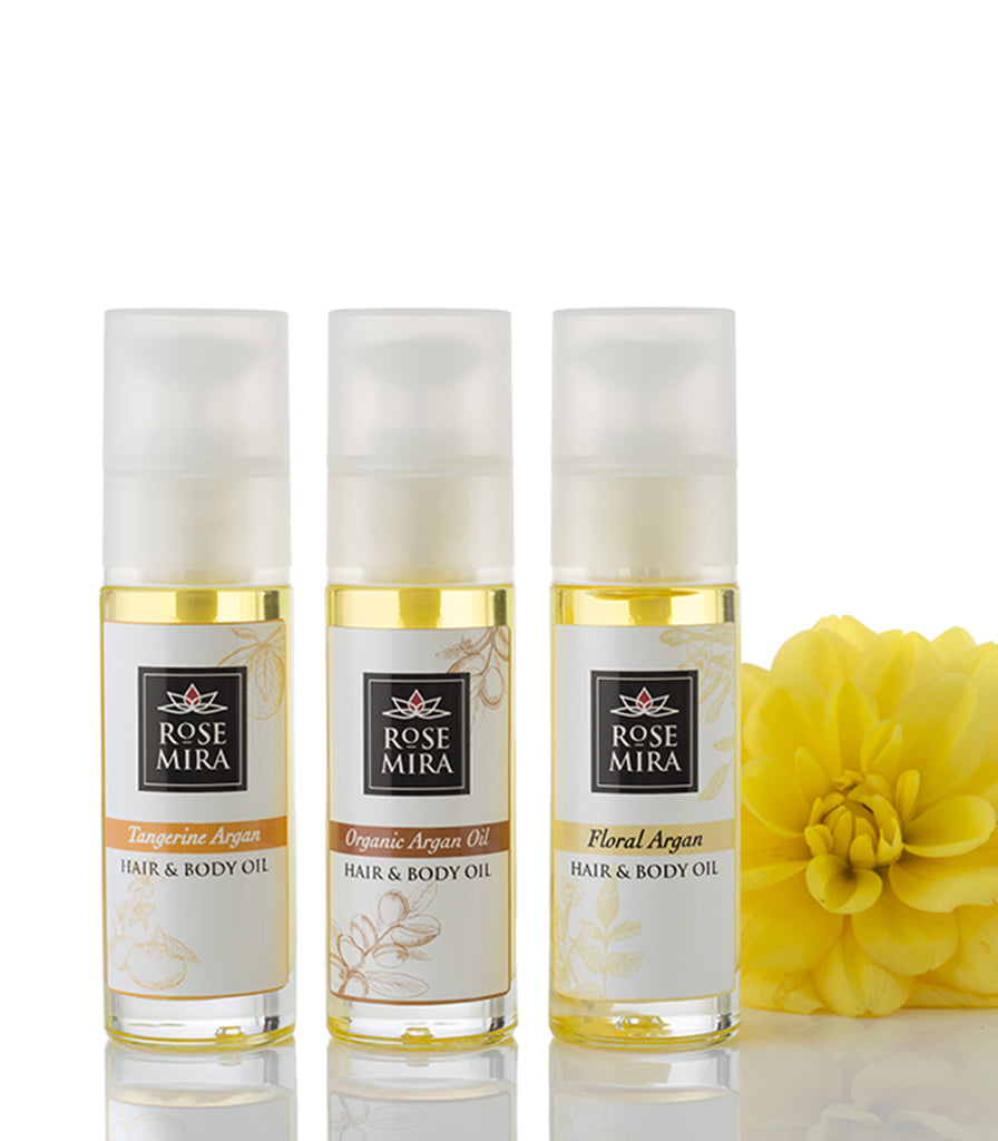 Three Argan Hair and Body Oil Flavors with a yellow flower