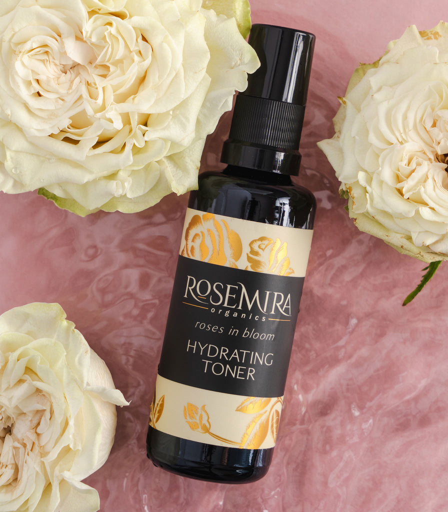 Roses in Bloom Hydrating Toner on light pink water with white roses.