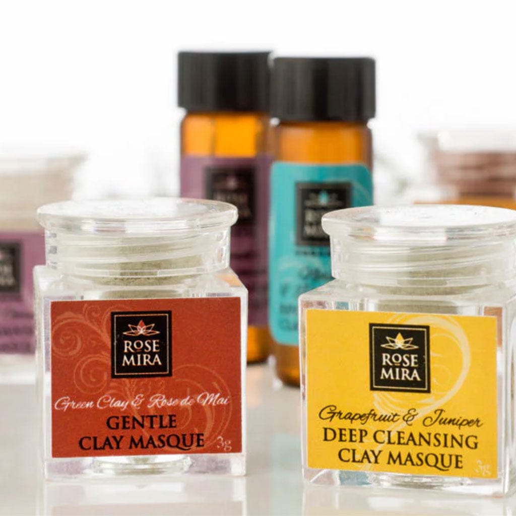 A row of Rosemira Organics samples in clear and amber bottles.