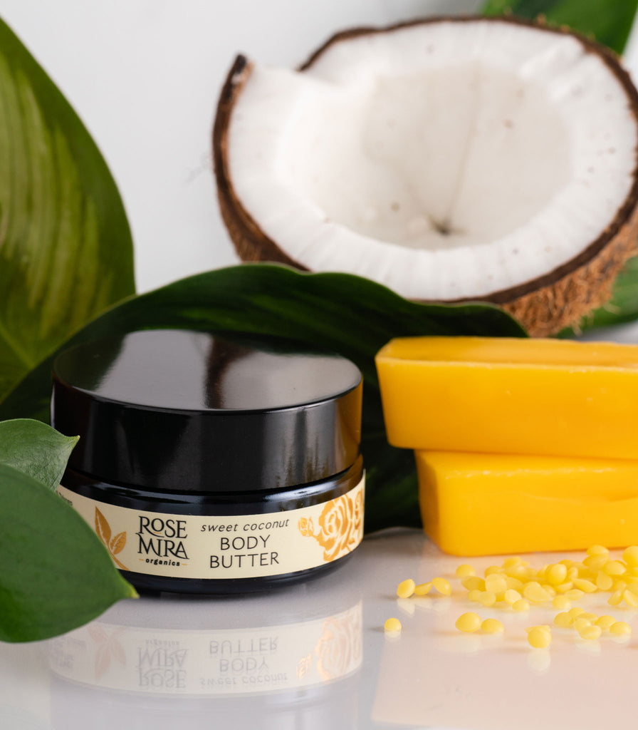 Sweet Coconut Body Butter with ingredients and green leaves