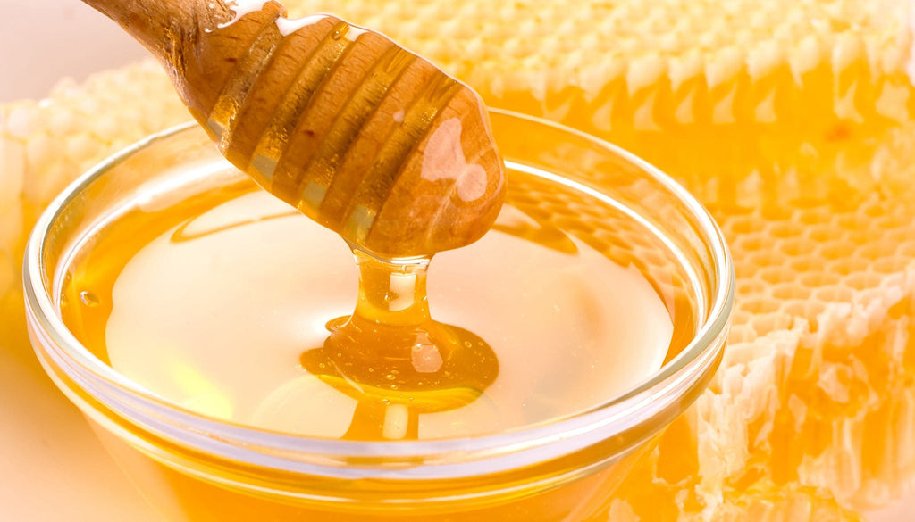 Golden honey in a jar, showcasing Rosemira Skincare's natural ingredients