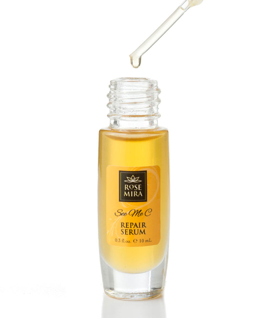Dropper in action releasing a golden drop of organic vitamin c serum into its bottle