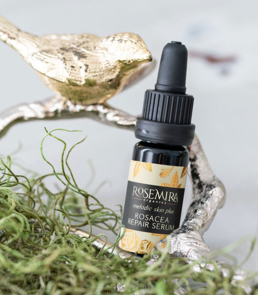 Melodic Skin Plus Rosacea Recovery Serum nestled in a silver tray with moss and a bird