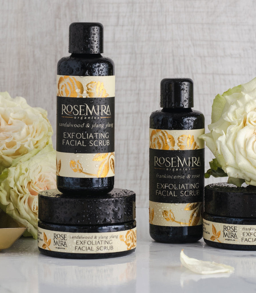 Sandalwood and Ylang Ylang Exfoliating Facial Srub splashed with water and white roses