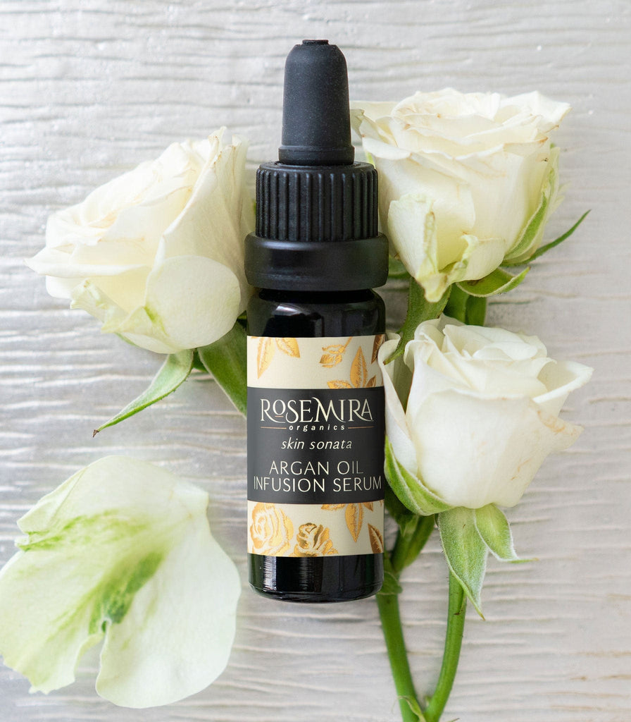 Skin Sonata Argan Oil Infusion Serum nestled in three white roses