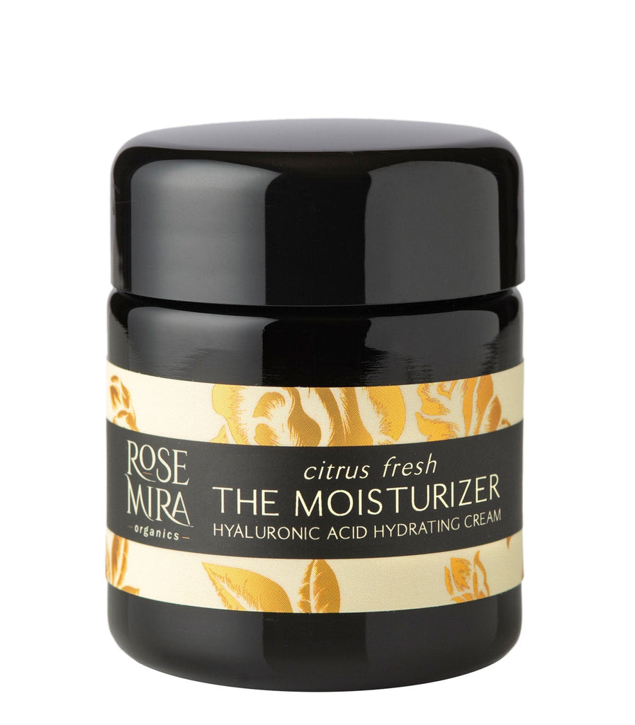 The Moisturizer in Citrus Fresh in black miron glass on white