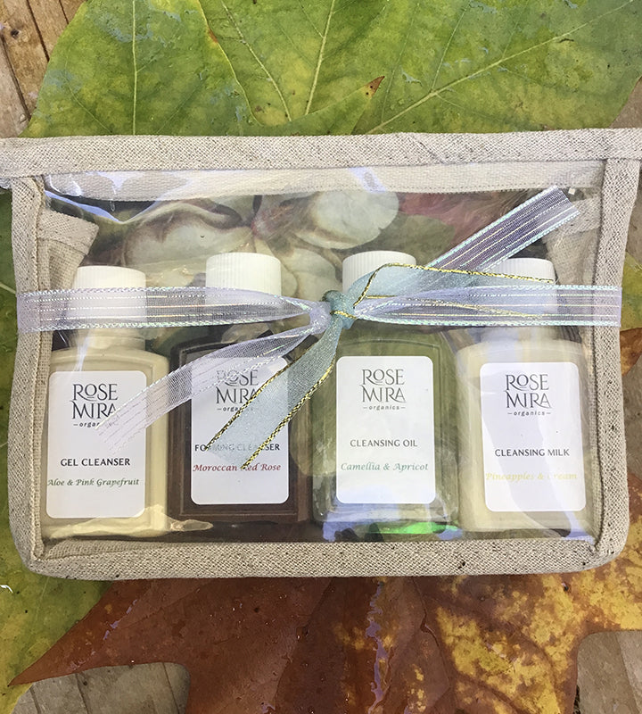 Four Rosemira cleansers in travel size in a gift pouch with ribbon